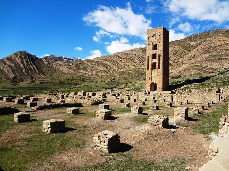 Rows of stone column bases of the great mosque at Beni Hammad, the minaret beyond