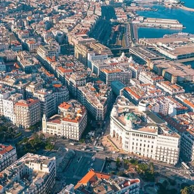 Central Algiers and its port seen from the air, white buildings running down to the sea