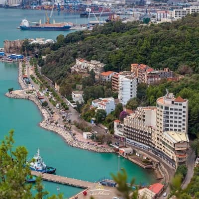 The port and town of Béjaïa seen from above, mountains behind the harbour