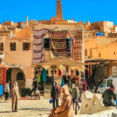 Carpets for sale in the market square of Ghardaïa below the minaret