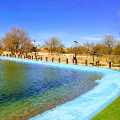 A long ornamental pool in a park in Sétif