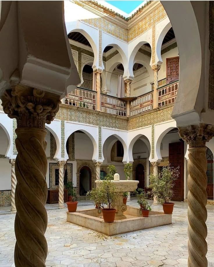 Twisted marble columns framing the courtyard fountain of an Ottoman palace in the Casbah