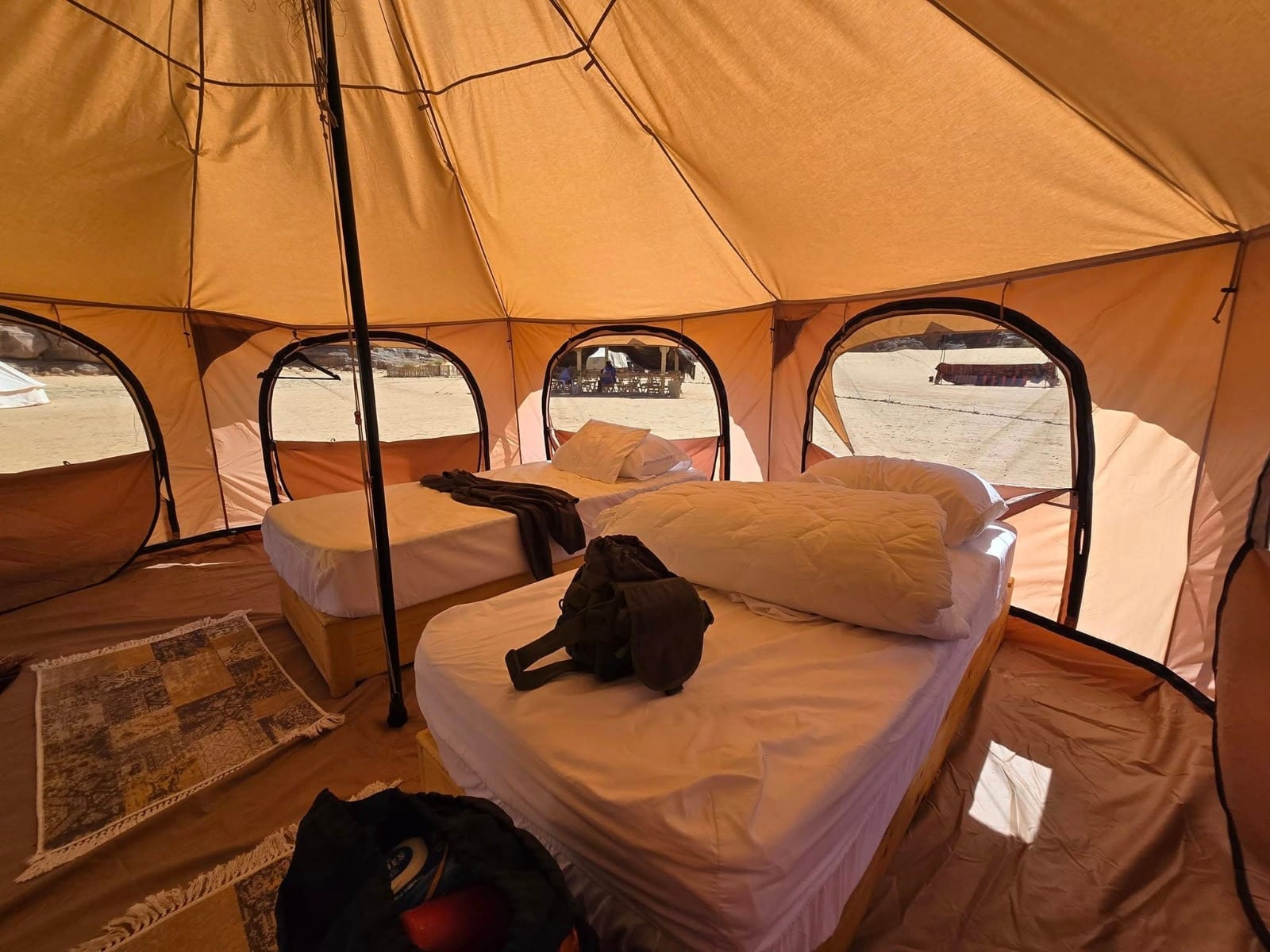Twin beds inside a canvas bell tent at the luxury camp near Djanet